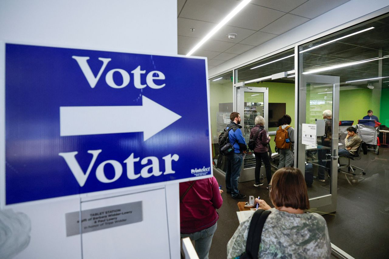 People wait in line to cast their early votes at the Madison Public Library Central in Madison, Wisconsin, on October 22.