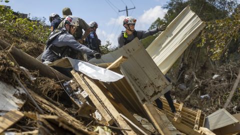 A FEMA search and rescue team from Maryland search for human remains in debris from a structure in Swannanoa on Oct. 6, 2024, after Tropical Storm Helene flooded the Swannanoa River.  (Travis Long/The News & Observer/Tribune News Service via Getty Images)