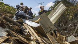A FEMA search and rescue team from Maryland search for human remains in debris from a structure in Swannanoa on Oct. 6, 2024, after Tropical Storm Helene flooded the Swannanoa River.  (Travis Long/The News & Observer/Tribune News Service via Getty Images)