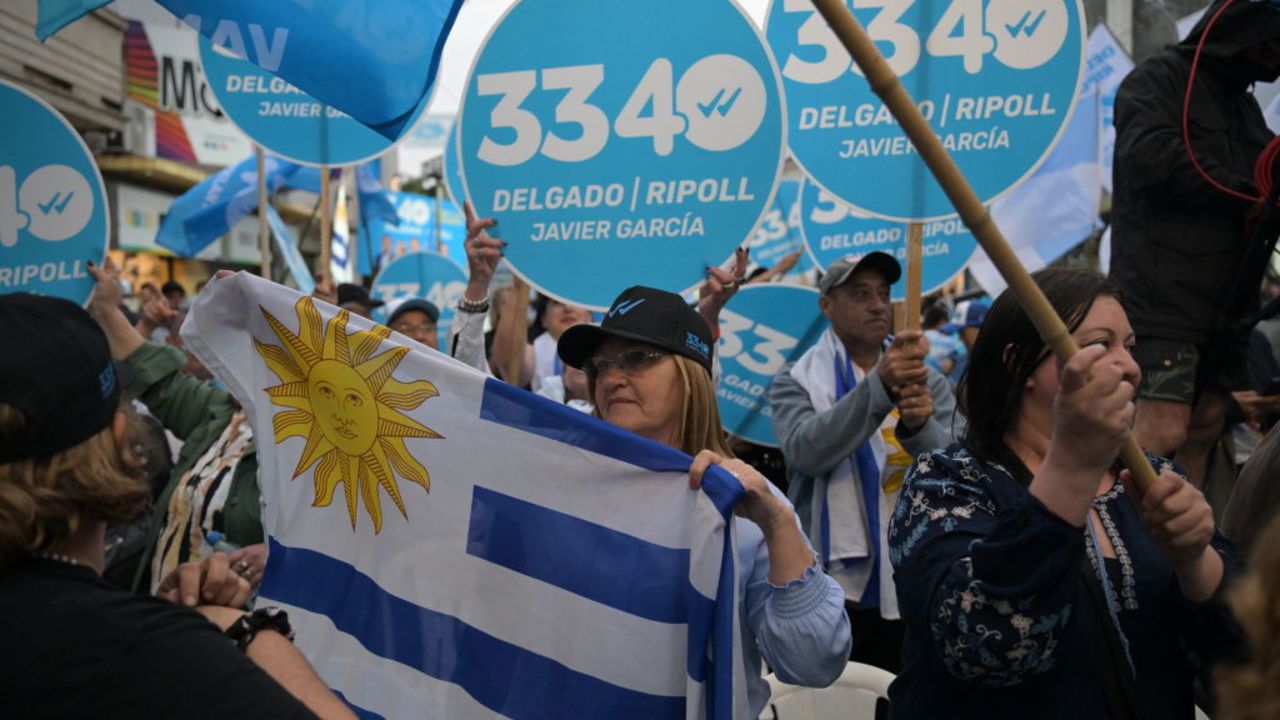 Supporters of Uruguay's presidential candidate for the Partido Nacional (National Party) Alvaro Delgado attend the campaign closing rally in Las Piedras, Canelones, Uruguay, on October 22, 2024, ahead of the upcomig prsidential election. If no candidate gets more than 50 percent on the October 27 presidential election, the two most voted will have to face a runoff on November 24. (Photo by EITAN ABRAMOVICH / AFP) (Photo by EITAN ABRAMOVICH/AFP via Getty Images)