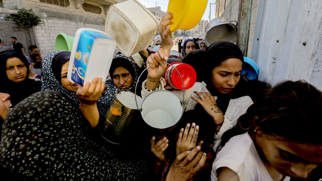 People attempt to secure aid at a food distribution center in Gaza City on October 21.