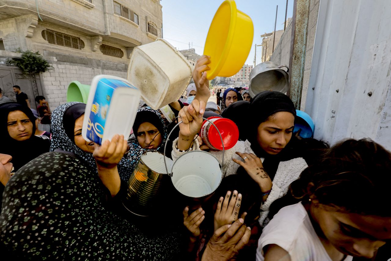 People attempt to secure aid at a food distribution center in Gaza City on October 21.