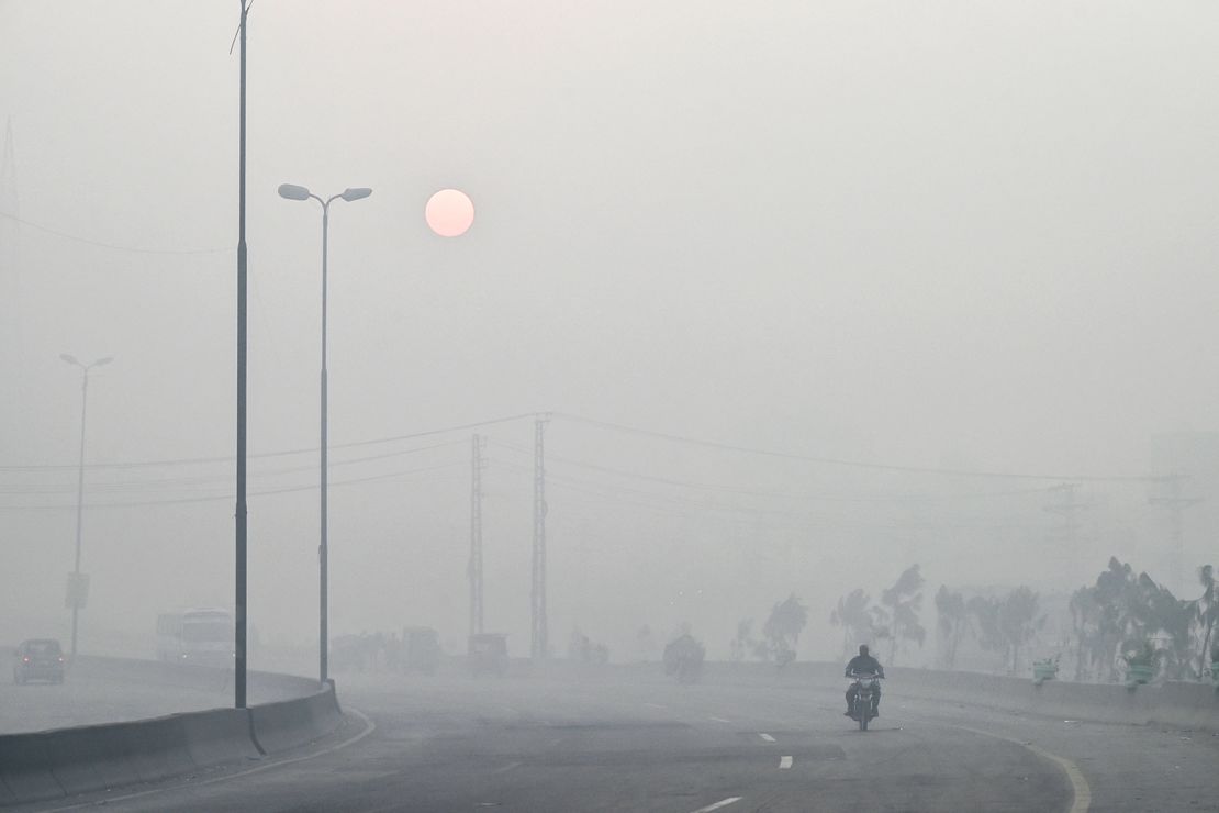 A man rides a motorbike along a street engulfed in dense smog, in Lahore, Pakistan on October 23.