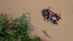 An aerial view shows a coast guard rescue boat evacuating residents to safer gounds in Polangui town, Albay province south of Manila, Philippines on October 23, 2024. Torrential rains driven by the storm have turned streets into rivers, submerged entire villages and buried some vehicles up to their door handles in volcanic sediment knocked loose by the downpour.