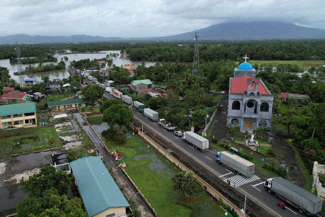 Trucks are stranded along a flooded highway in Nabua town, Camarines Sur province, south of Manila, Philippines, October 23, 2024.