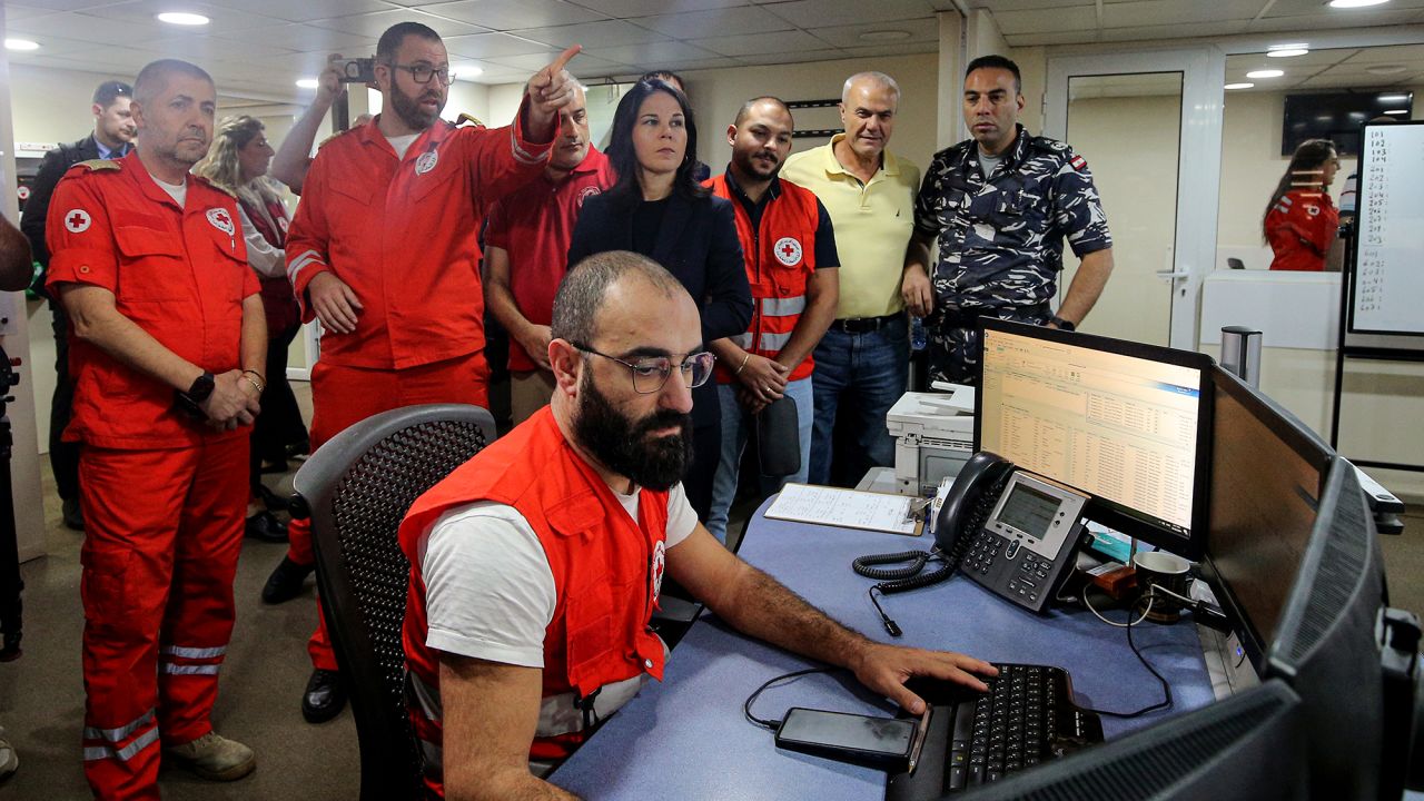 German Foreign Minister Annalena Baerbock, center, is briefed on safety, security and strategic management during her visit to the Red Cross Crisis Response Center in Hazmieh, Lebanon, on October 23.