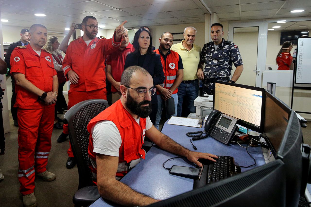 German Foreign Minister Annalena Baerbock, center, is briefed on safety, security and strategic management during her visit to the Red Cross Crisis Response Center in Hazmieh, Lebanon, on October 23.