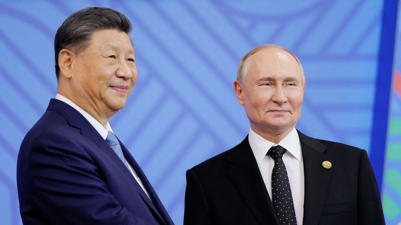Russian President Vladimir Putin greets Chinese President Xi Jinping during an official welcoming ceremony for delegations' heads at the BRICS summit in Kazan on October 23, 2024. (Photo by Maxim Shemetov / POOL / AFP) (Photo by MAXIM SHEMETOV/POOL/AFP via Getty Images)