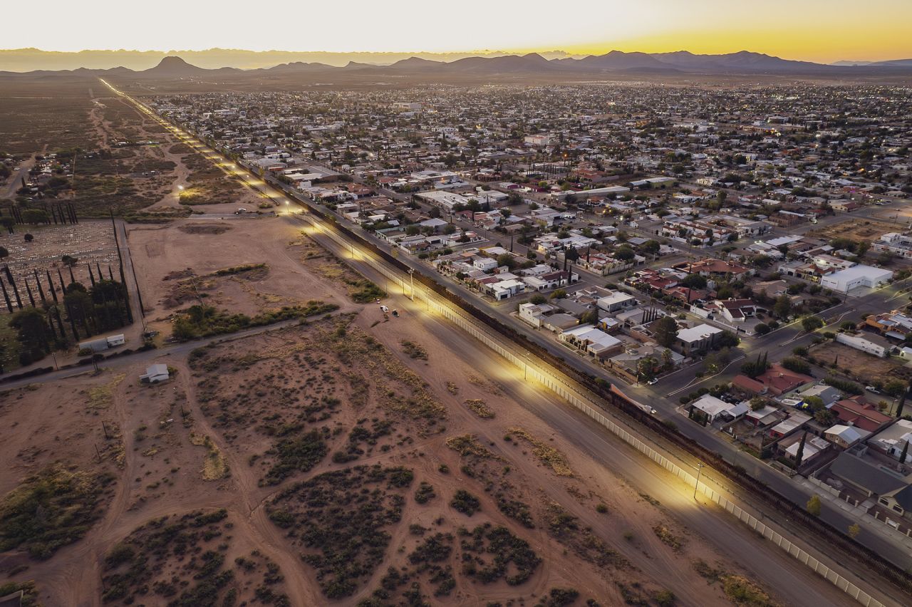 An aerial view shows the south side of the city of Douglas next to the double wall on the US-Mexico next to the Mexican city of Agua Prieta, on October 15.