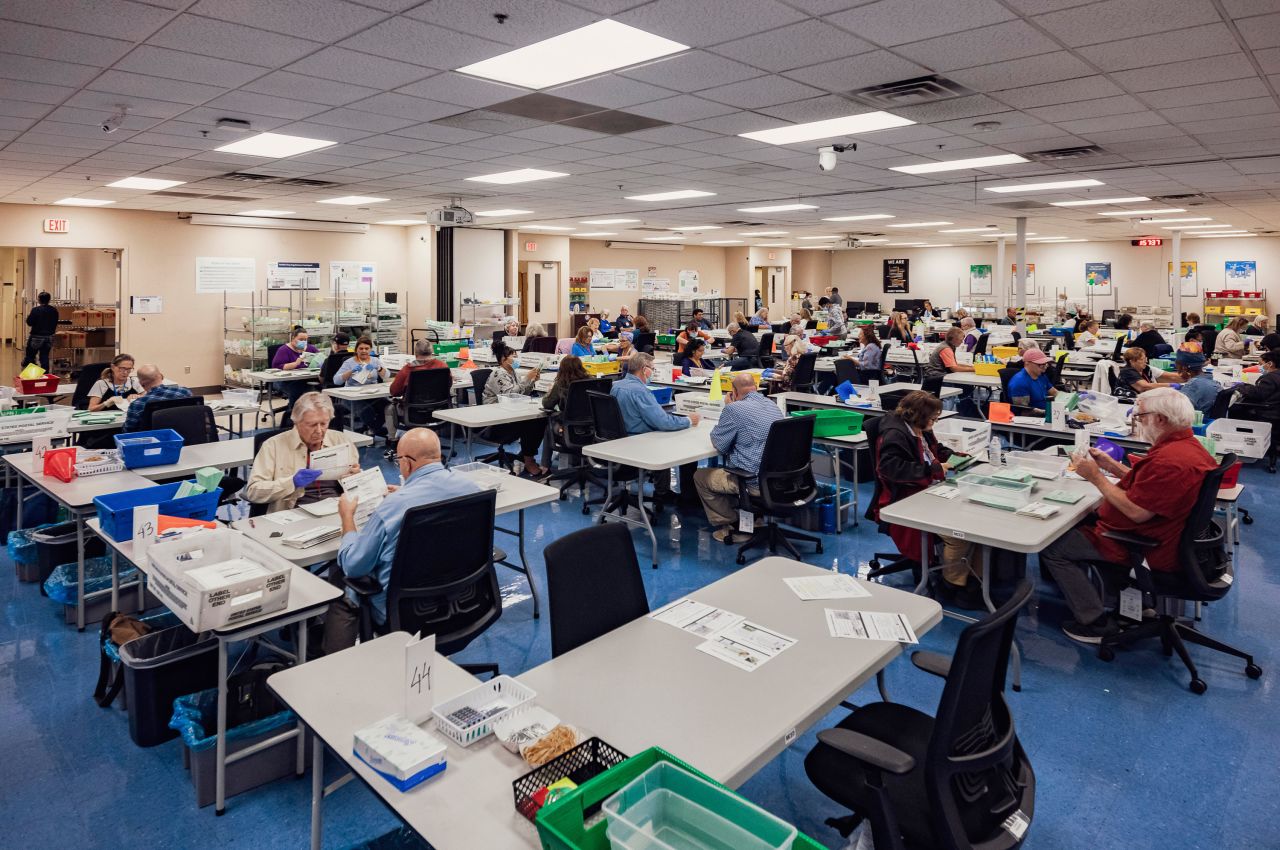 Election workers open and sort envelopes with 2024 General Election ballots at the Maricopa County Tabulation and Election Center in Phoenix, Arizona, on October 23.