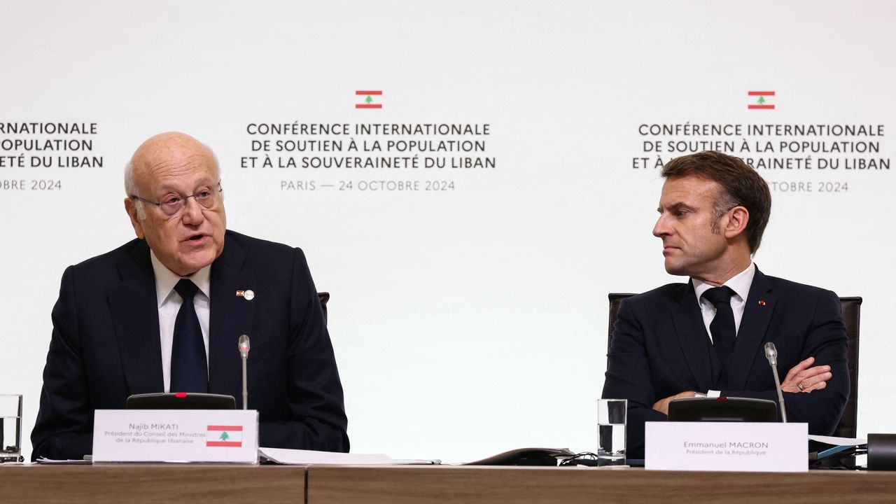 Lebanon's Prime Minister Najib Mikati, left, speaks next to France's President Emmanuel Macron during an international press conference in support of Lebanon, in Paris, France, on October 24.