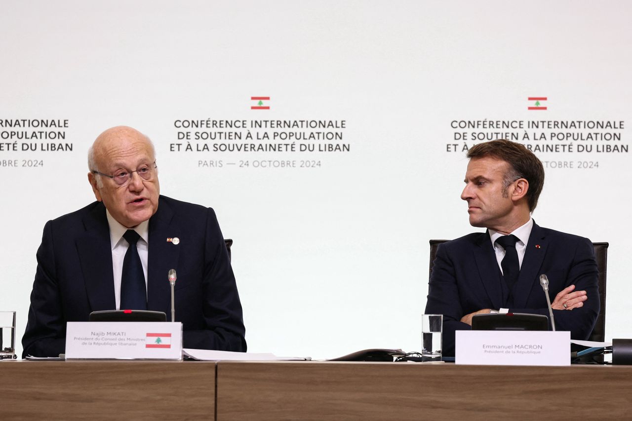 Lebanon's Prime Minister Najib Mikati, left, speaks next to France's President Emmanuel Macron during an international press conference in support of Lebanon, in Paris, France, on October 24.