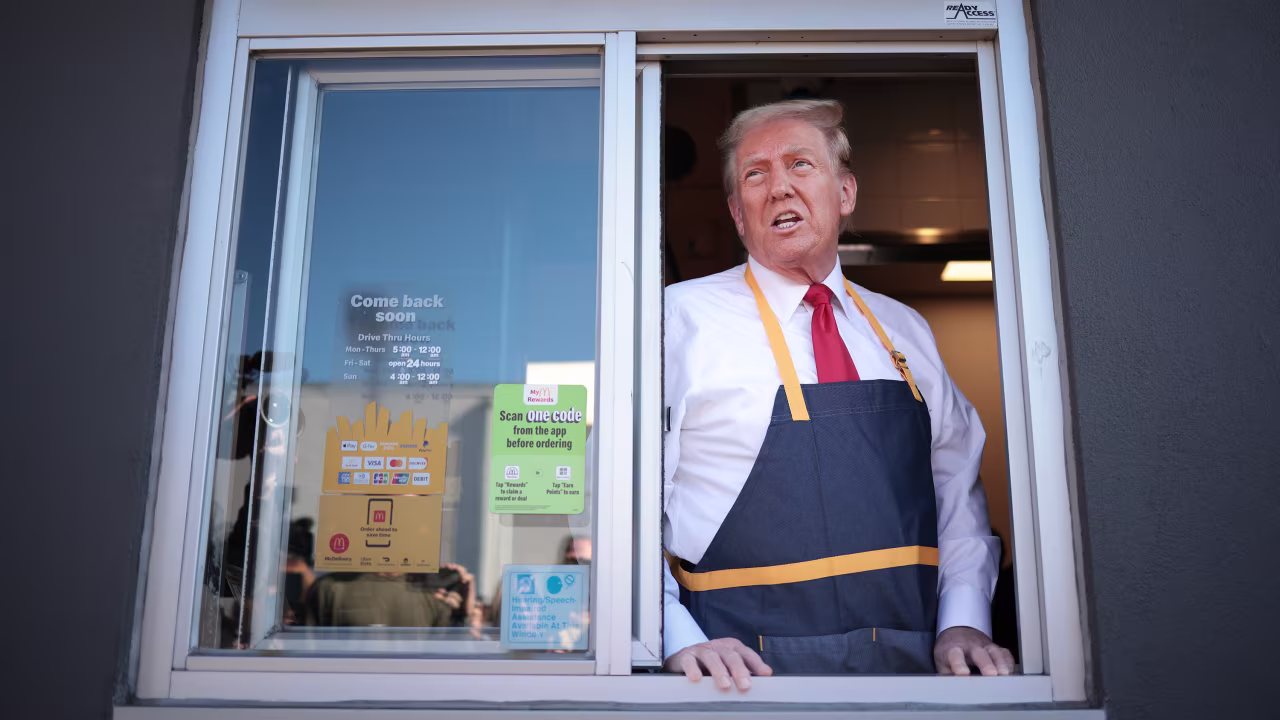 Republican presidential nominee and former US President Donald Trump answers questions as he works the drive-through line at a McDonald's restaurant in Feasterville-Trevose, Pennsylvania, on October 20.