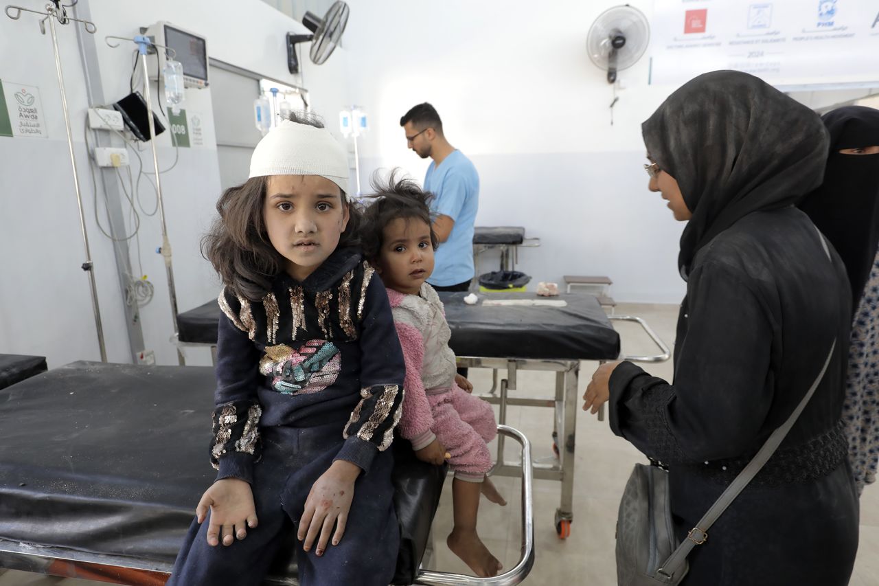 Wounded people, including children and women, are brought to Al-Awda Hospital for treatment after the Israeli army attacked a school sheltering displaced Palestinians at Nuseirat refugee camp, Gaza, on October 24.