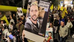 A protester marches with the portrait of Israeli hostages Elkana Bohbot (34) with others during a demonstration by the families of the hostages taken captive in the Gaza Strip by Palestinian militants during the October 7, 2023 attacks, calling for action to release the hostages, outside the Israeli Prime Minister's residence in Azza (Gaza) Street in central Jerusalem on October 24, 2024 amid Israel's ongoing war with Hamas. (Photo by Ahmad GHARABLI / AFP) (Photo by AHMAD GHARABLI/AFP via Getty Images)