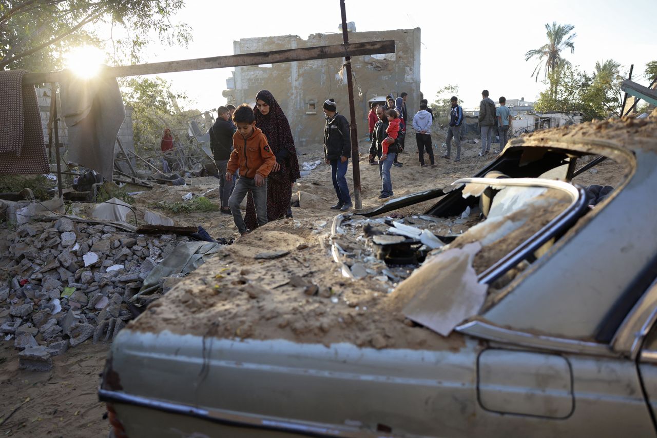 People inspect the damage at the site of an Israeli strike in Khan Younis, Gaza, on October 25.