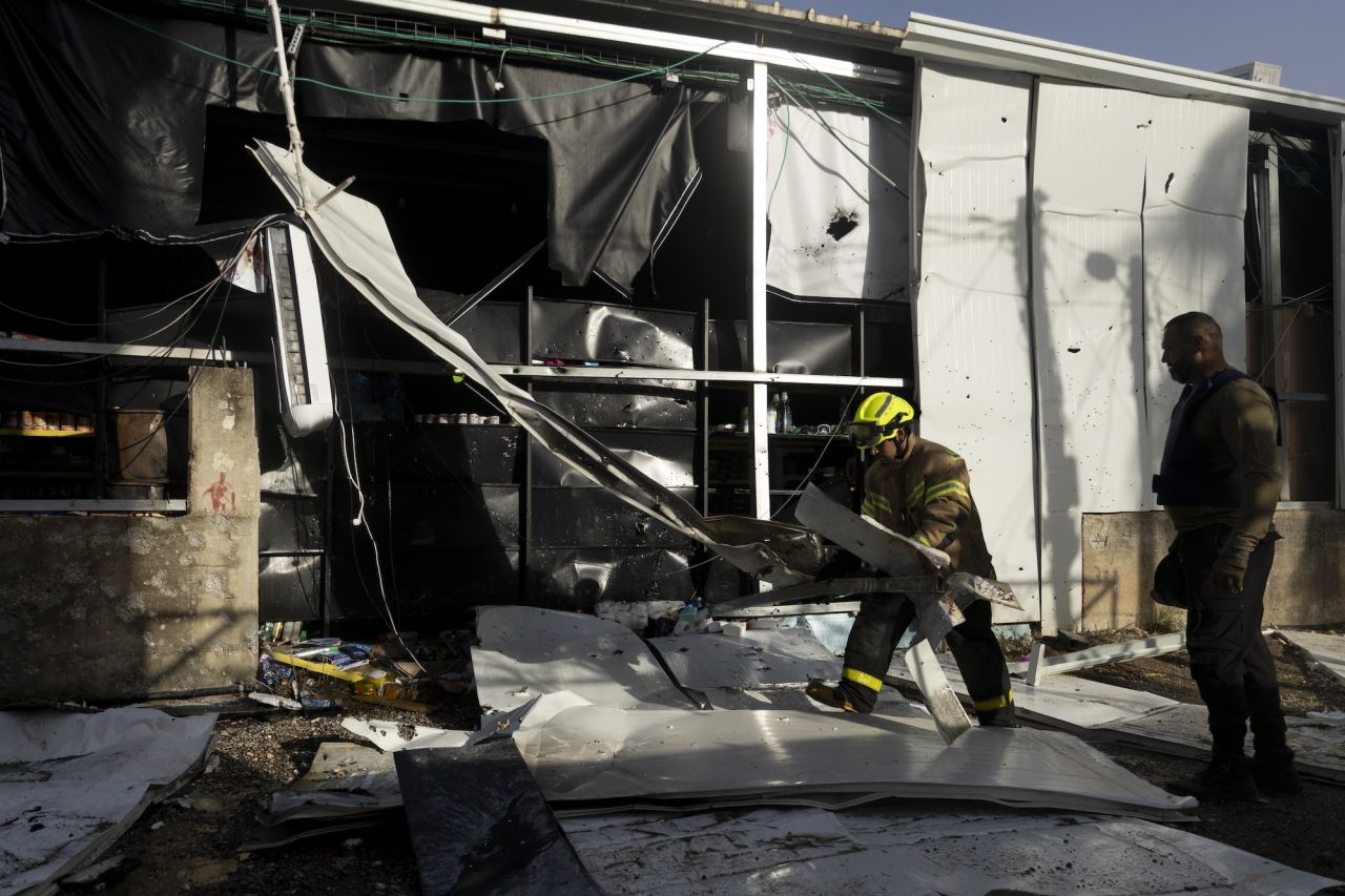 Rescue workers work at the scene of an attack following a barrage of incoming rockets on Friday in Majd Al-Krum, Israel.