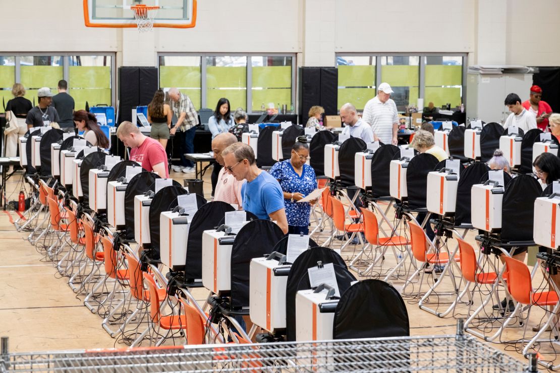 Voters cast their votes during early voting at a polling place in Houston on October 25, 2024.