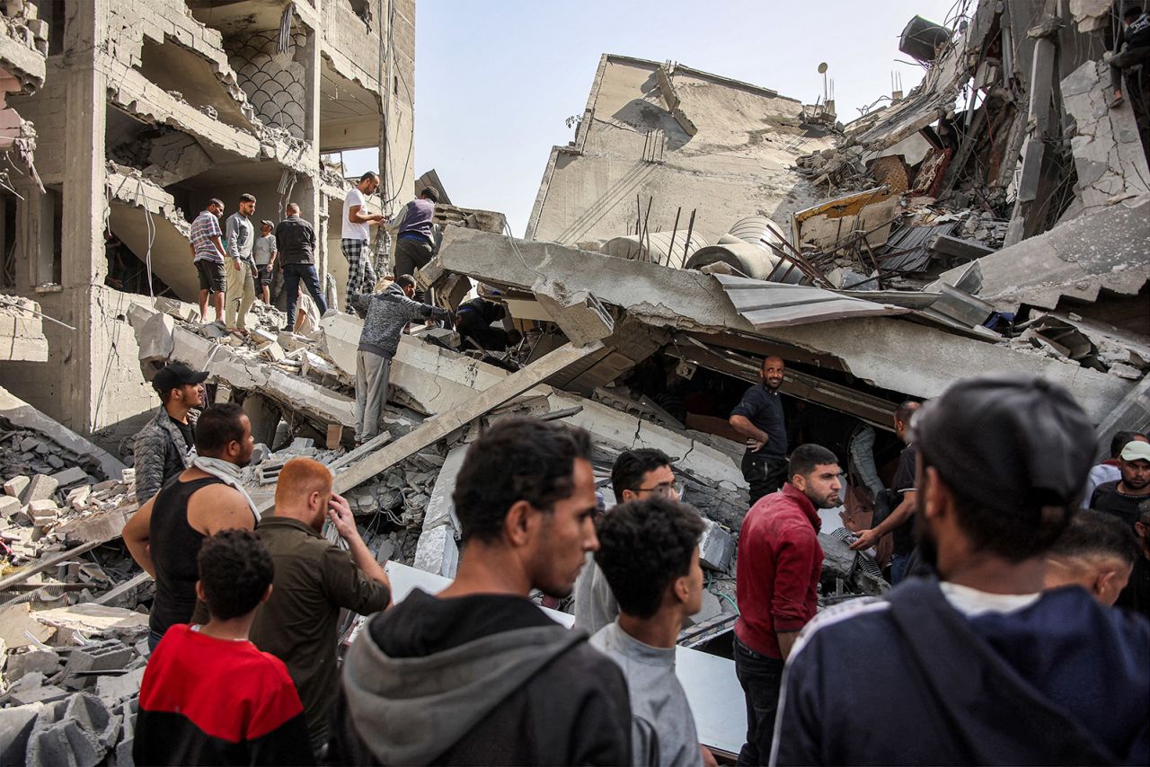 People search for survivors and victims in the rubble of a four-story house, following Israeli bombardment in the Zarqa neighborhood in the north of Gaza City on October 26, 2024.