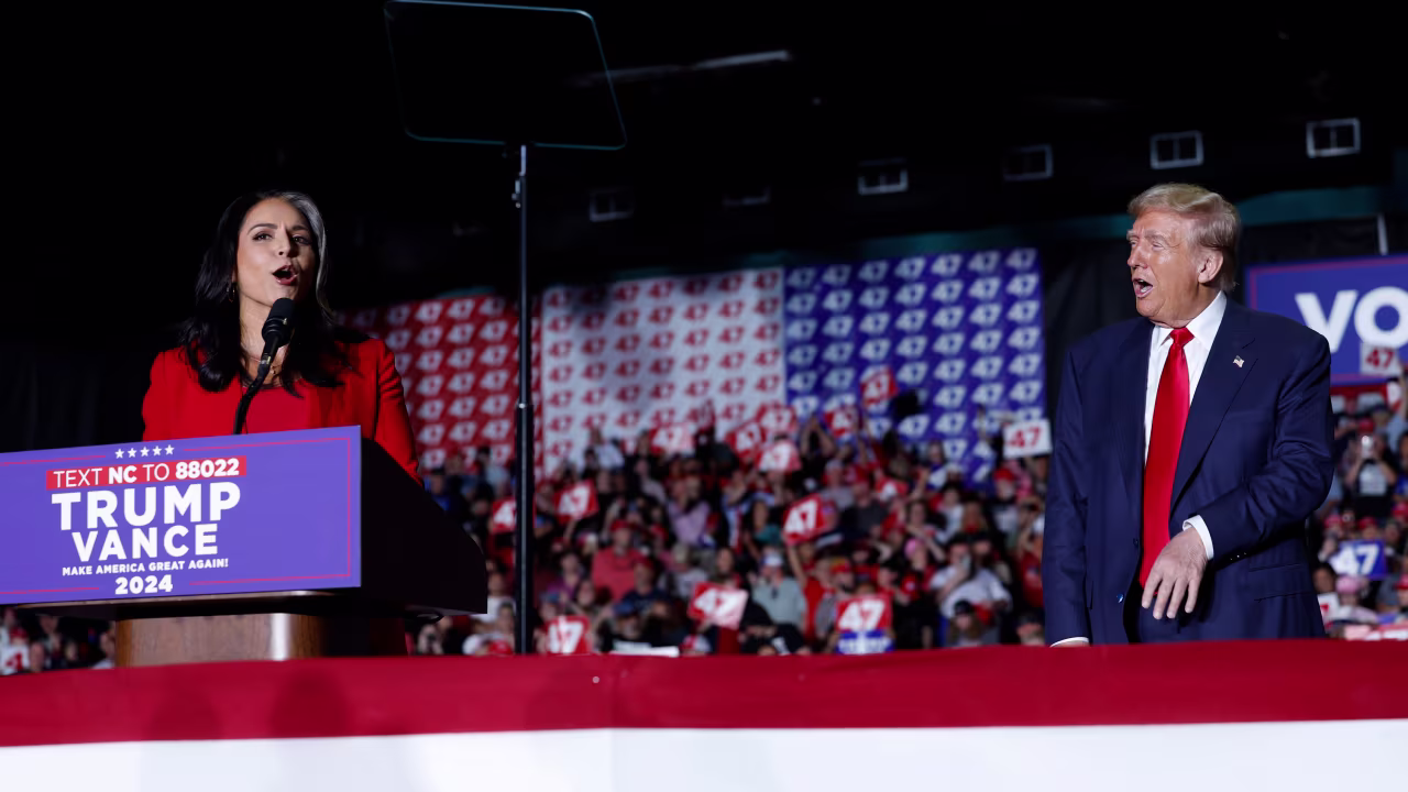 Former US Representative Tulsi Gabbard announces that she is joining the Republican party as Donald Trump reacts to her speaking at a campaign rally in Greensboro, North Carolina, on October 22.