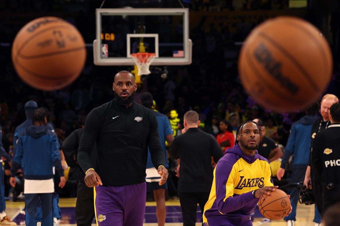 Bronny James and LeBron James warm up before the game against the Minnesota Timberwolves.