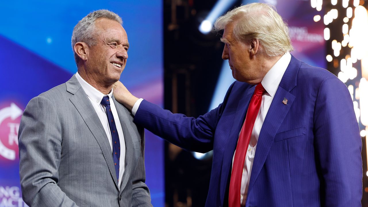 Republican presidential candidate and former U.S. President Donald Trump welcomes Robert F. Kennedy Jr. to the stage during the Turning Point Action campaign rally at Gas South Arena on October 23, 2024 in Duluth, Georgia. Trump is campaigning across Georgia today, along with Democratic presidential candidate and Vice President Kamala Harris, in an effort to win over voters in the battleground state.