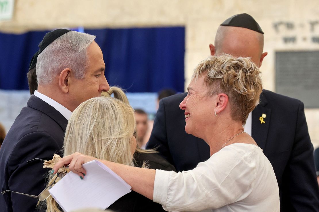 Iris Haim (R), the mother of hostage Yotam Haim, is consoled by Israeli Prime Minister Benjamin Netanyahu (L) and his wife Sara (2nd-L) during a memorial ceremony for Israelis killed on the Hebrew calendar anniversary of the October 7 Hamas attack, in Jerusalem on October 27, 2024.