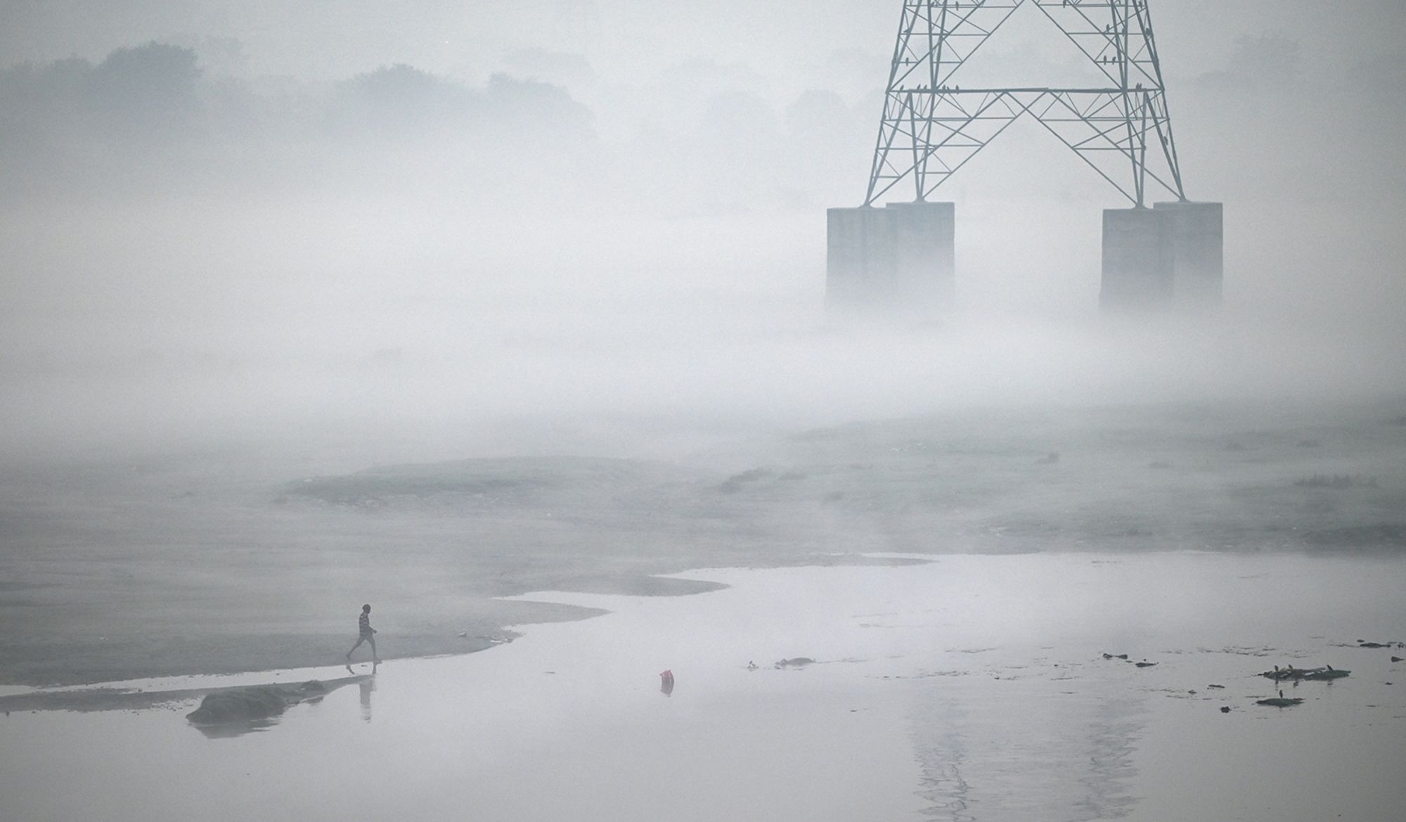 Morning haze envelops the bank of the River Yamuna, on October 27, 2024 in New Delhi.