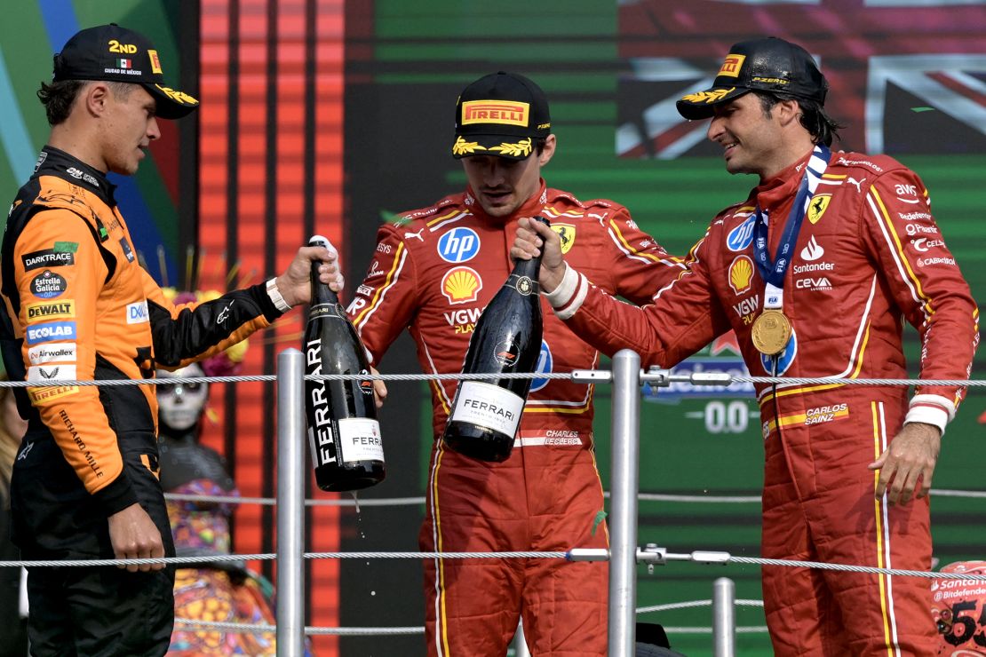 Sainz celebrates on the podium with Lando Norris and his teammate Charles Leclerc.