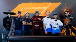 MEXICO CITY, MEXICO - OCTOBER 24: Max Verstappen of the Netherlands and Oracle Red Bull Racing, Sergio Perez of Mexico and Oracle Red Bull Racing, Liam Lawson of New Zealand and Visa Cash App RB and Yuki Tsunoda of Japan and Visa Cash App RB pose for a photo with Day of the Dead performers in the Paddock during previews ahead of the F1 Grand Prix of Mexico at Autodromo Hermanos Rodriguez on October 24, 2024 in Mexico City, Mexico. (Photo by Rudy Carezzevoli/Getty Images)