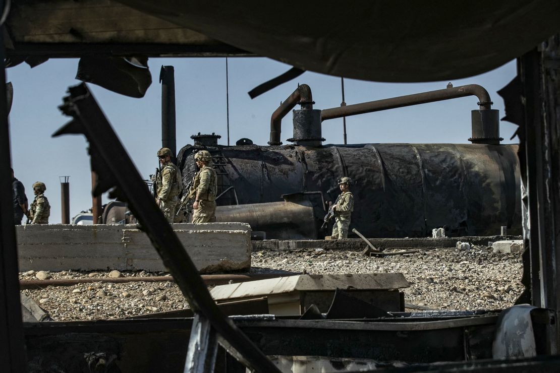 US soldiers inspect the site of reported Turkish shelling days earlier on an oil extraction facility on the outskirts of Rumaylan, in Syria's Kurdish-controlled northeastern Hasakeh province on October 28.