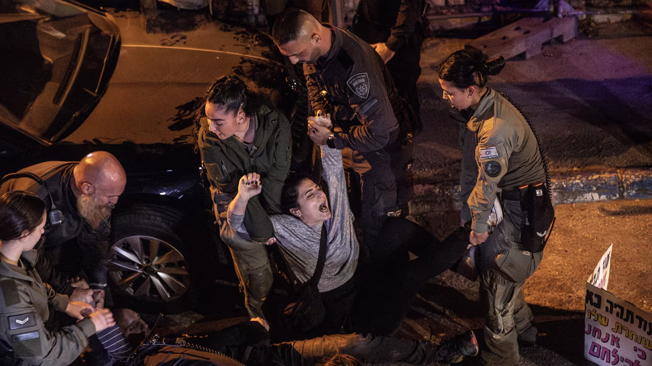 Police drag a protester away near Israeli Prime Minister Benjamin Netanyahu's residence in Jerusalem on October 28.