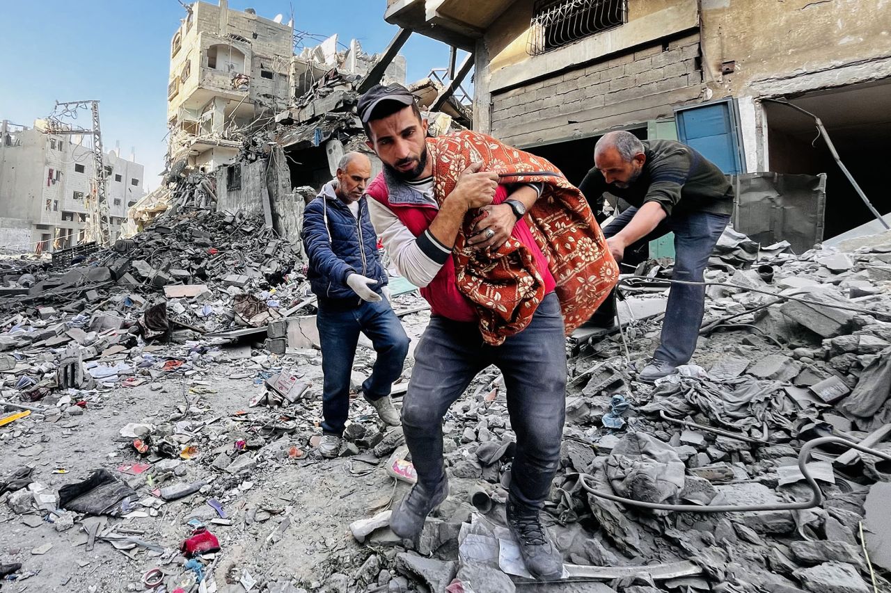 PalestinianS remove a body from the rubble of a building hit by an Israeli strike in Beit Lahiya, Gaza, on October 29.