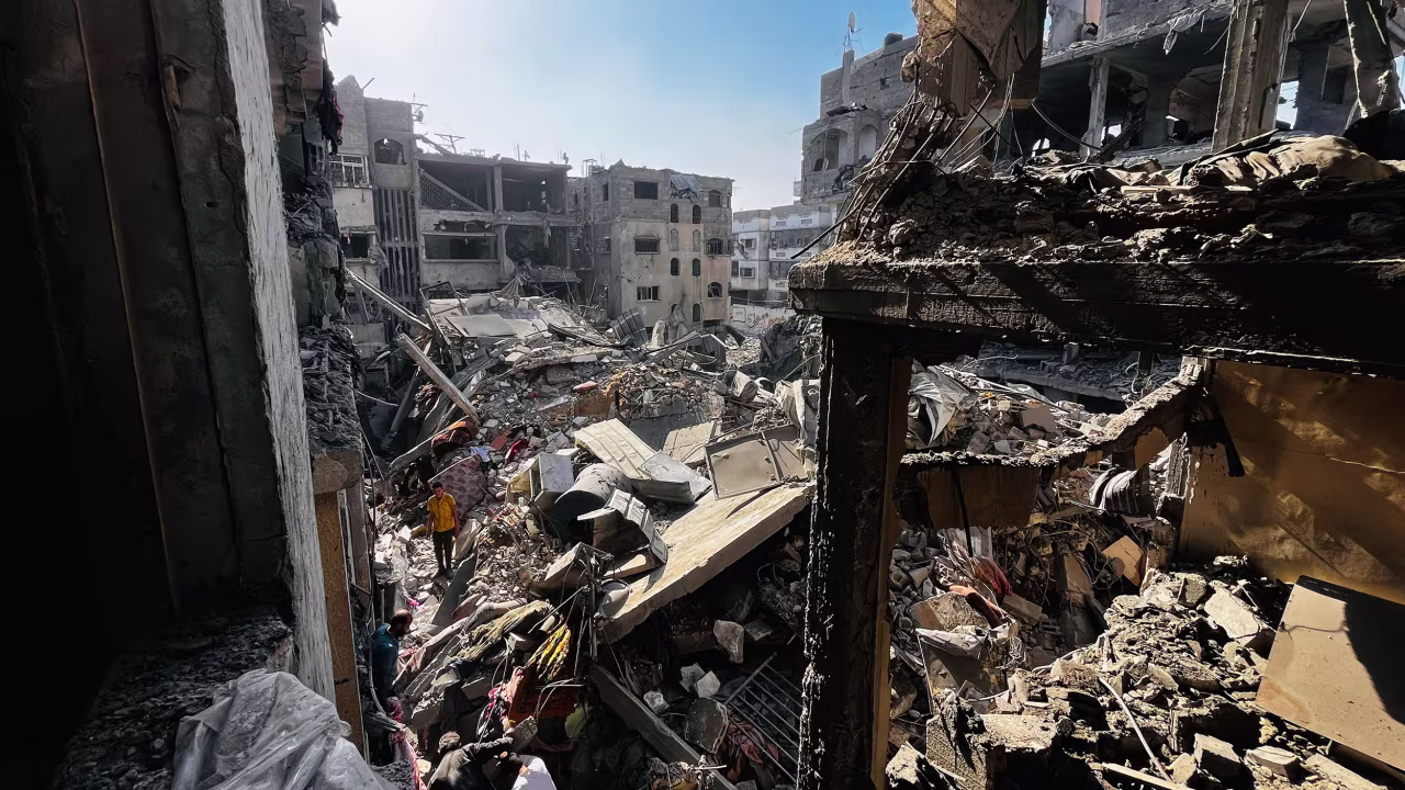 People search through the rubble of a building after an Israeli strike in Beit Lahia, Gaza on October 29.