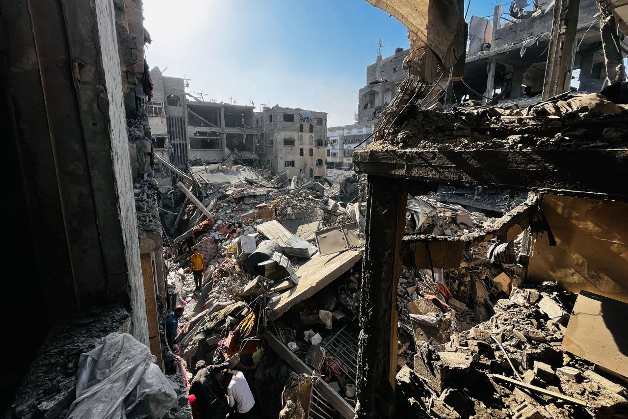 People search through the rubble of a building after an Israeli strike in Beit Lahia, Gaza on October 29.