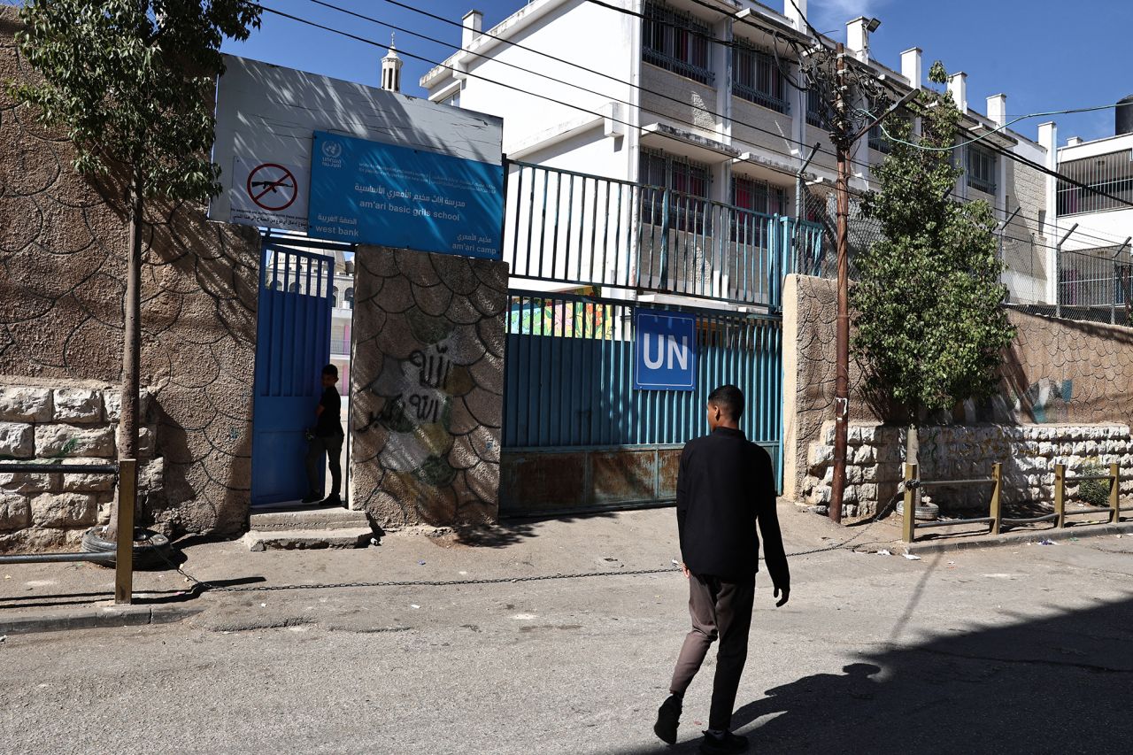 A Palestinian man walks past the UNRWA school in the Al-Amari refugee camp near Ramallah, in the occupied West Bank on October 29.