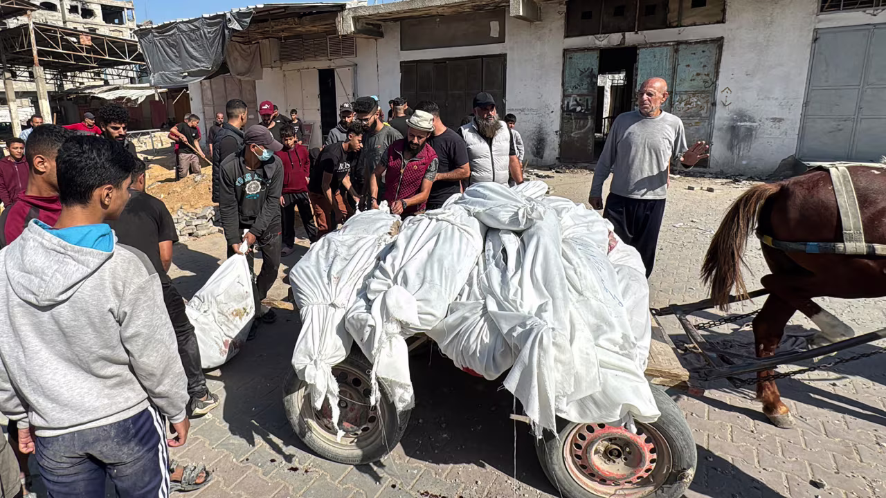 Palestinians transport bodies ahead of their funeral in Beit Lahiya, Gaza, on October 29.