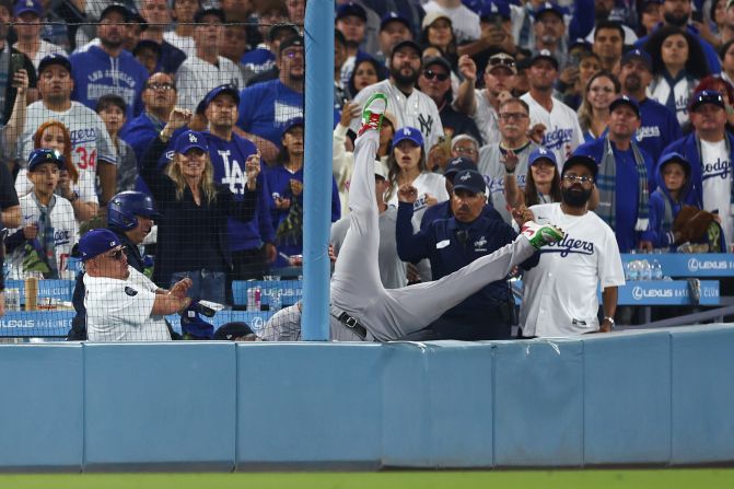 Alex Verdugo of the Yankees dives to catch a foul hit by the Dodgers' Shohei Ohtani in the tenth inning of Game 1.