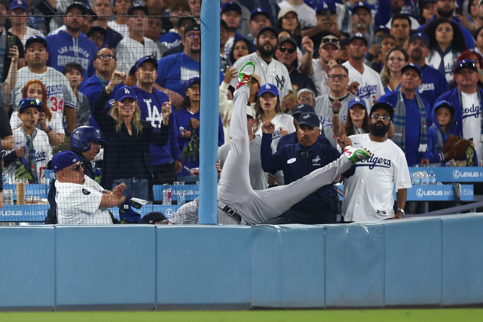 Alex Verdugo of the Yankees dives to catch a foul hit by Ohtani in the 10th inning of Game 1.