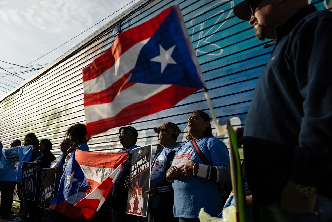 Supporters of Vice President and Democratic presidential candidate Kamala Harris hold Puerto Rican flags during a demonstration ahead of a campaign rally with former President and Republican presidential candidate Donald Trump in Allentown, Pennsylvania, on October 29.