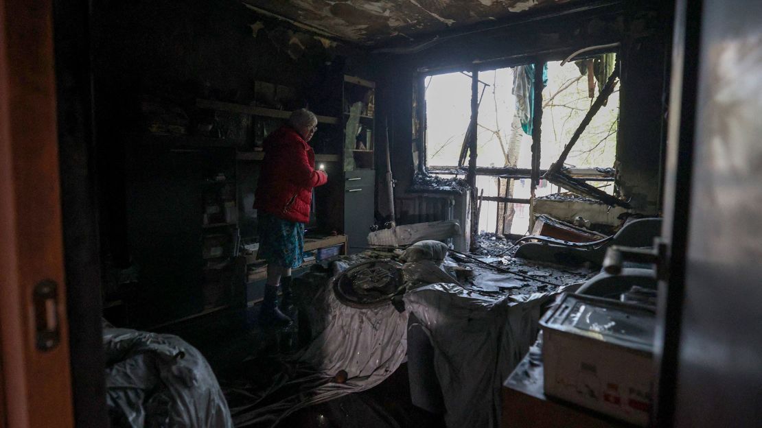 Resident Oksana Tereshchenko, 59, examines her bedroom after a drone strike in Kyiv, Ukraine, on October 30.