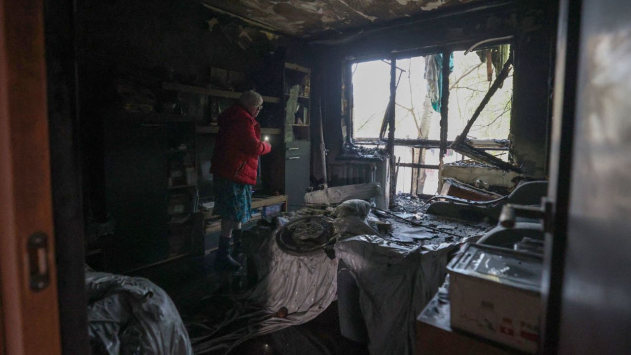 TOPSHOT - Resident Oksana Tereshchenko, 59, examines her bedroom, which burned down after the explosion of a drone strike in Kyiv, on October 30, 2024, amid the Russian invasion in Ukraine. Nine people, including an 11-year-old girl, were injured on October 29, 2024 in Kyiv, the capital of Ukraine, in a Russian drone attack that caused a fire in the affected building, Ukrainian authorities announced. (Photo by Anatolii STEPANOV / AFP) (Photo by ANATOLII STEPANOV/AFP via Getty Images)