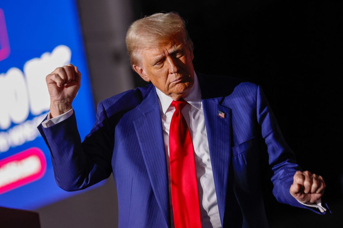 Donald Trump dances on stage during a campaign rally in Novi, Michigan, on October 26, 2024.