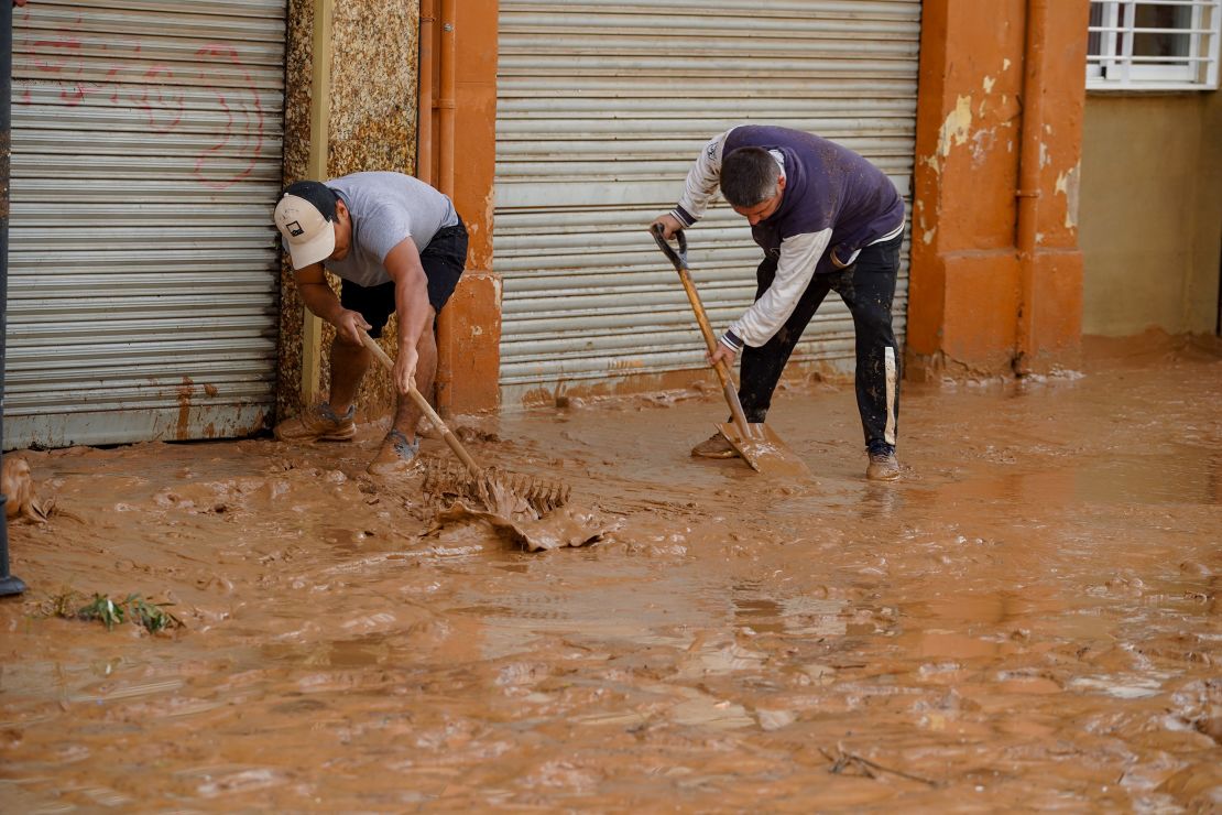 VALENCIA, SPAIN - OCTOBER 30: Residents clean the roads after a deluge brought up to 200 liters of rain per square meter in hours to towns in the Valencia region, Spain on October 30, 2024. Catastrophic flooding in the Spanish region of Valencia, according to preliminary data from the Center for Integrated Operational Coordination of the Ministry of the Interior 51 people died. The storm dumped a year's worth of rain in just a few hours, causing rivers to quickly overflow their banks and even triggering tornadoes. (Photo by Alex Juarez/Anadolu via Getty Images)