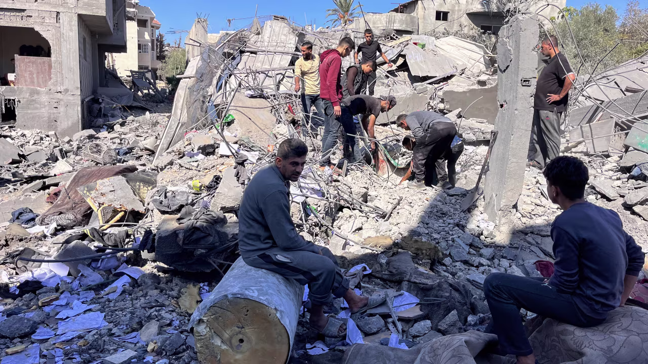 People search the rubble for missing persons at the site of an Israeli strike a day earlier that hit the Al-Loh family home in Beit Lahia, in the northern Gaza Strip on October 30.
