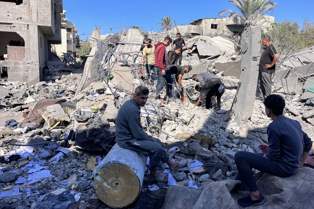 People search the rubble for missing persons at the site of an Israeli strike a day earlier that hit the Al-Loh family home in Beit Lahia, in the northern Gaza Strip on October 30.