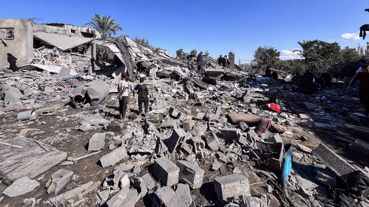 People search the rubble for missing persons on October 30 at the site of an Israeli strike a day earlier in Beit Lahia, in the northern Gaza Strip.