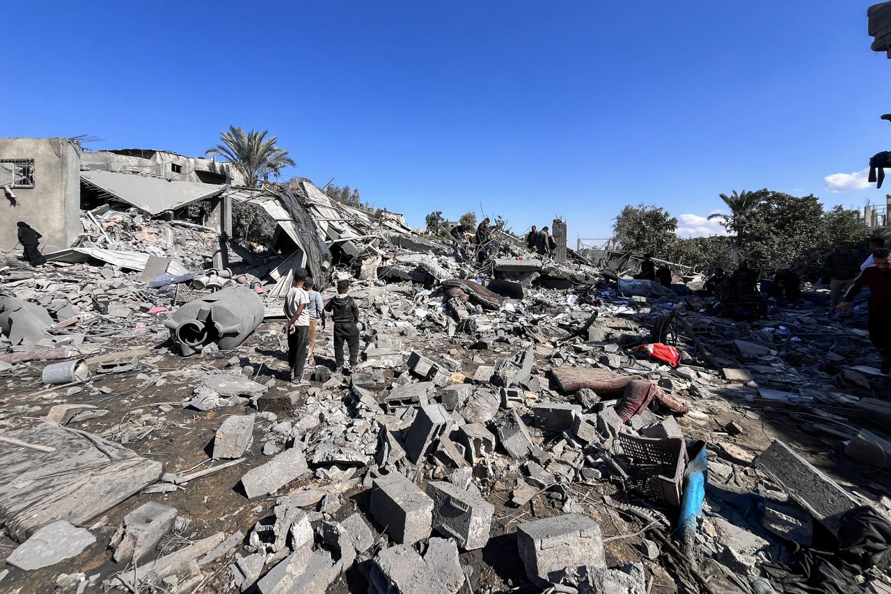 People search the rubble for missing persons on October 30 at the site of an Israeli strike a day earlier in Beit Lahia, in the northern Gaza Strip.