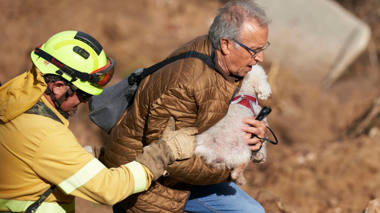 LETUR, SPAIN - OCTOBER 30: A man carries a dog after flash floods hit the region on October 30, 2024 in Letur, Albacete province, Spain. Spanish authorities said on Wednesday that at least 62 people had died in Spain, mostly in the Valencia region, overnight after flash-flooding followed heavy rain. Spain's meteorological agency had issued its highest alert for the region due to extreme rainfall. (Photo by Mateo Villalba Sanchez/Getty Images)