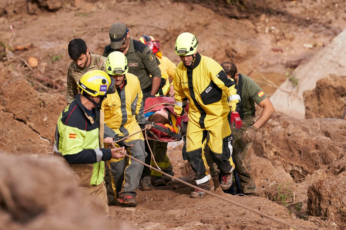 Emergency workers carry an injured person after flash floods hit the region on October 30, 2024 in Letur, Albacete province, Spain.